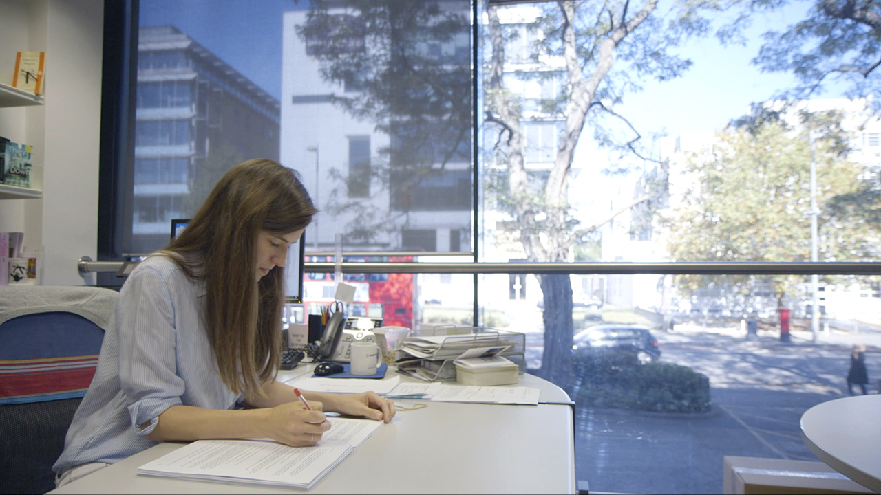 Frankie Gray editing manuscript at desk